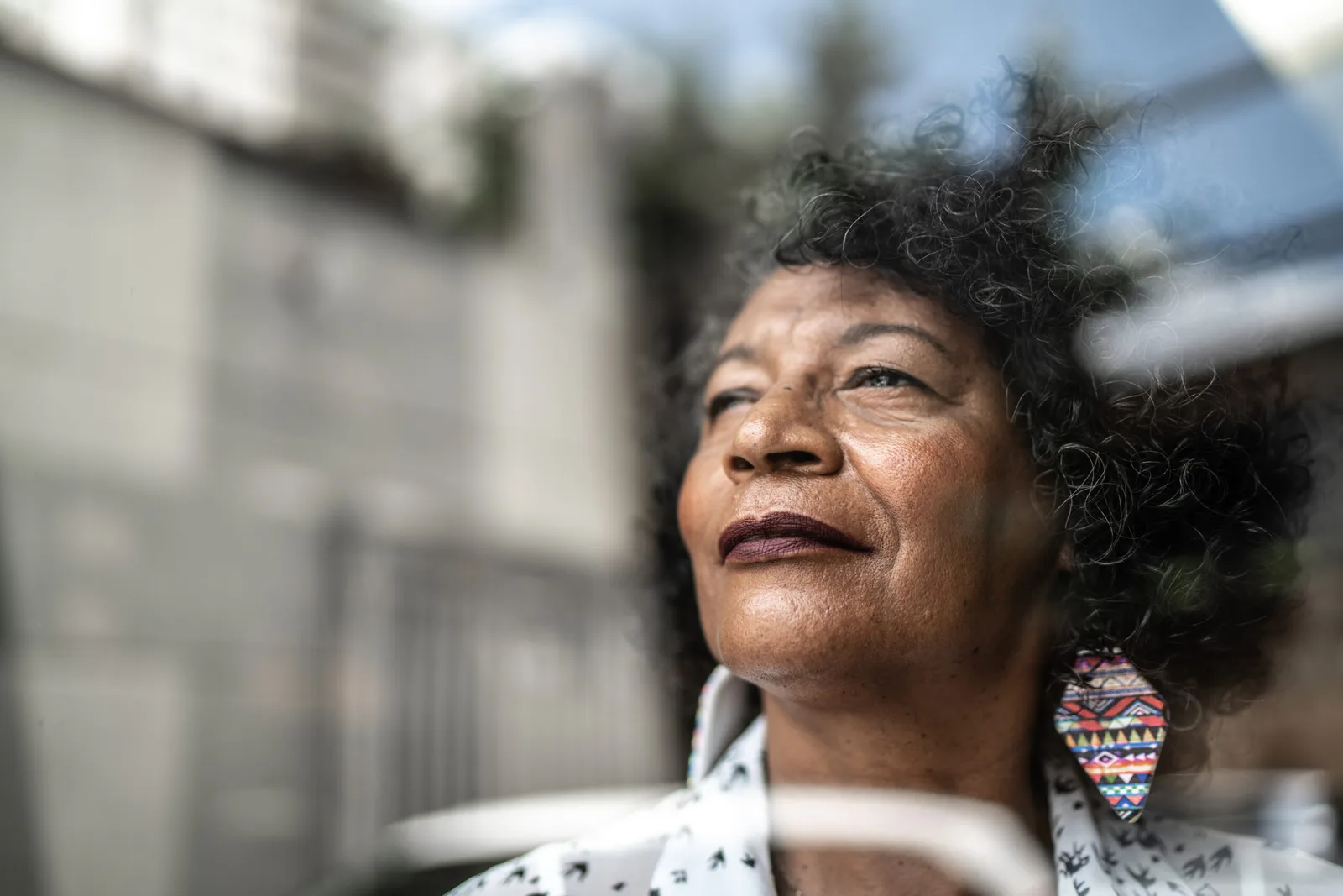 A woman looks up toward the light with a calm expression.