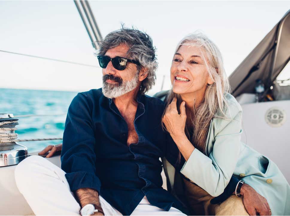 Older couple relaxing together on a sailboat
